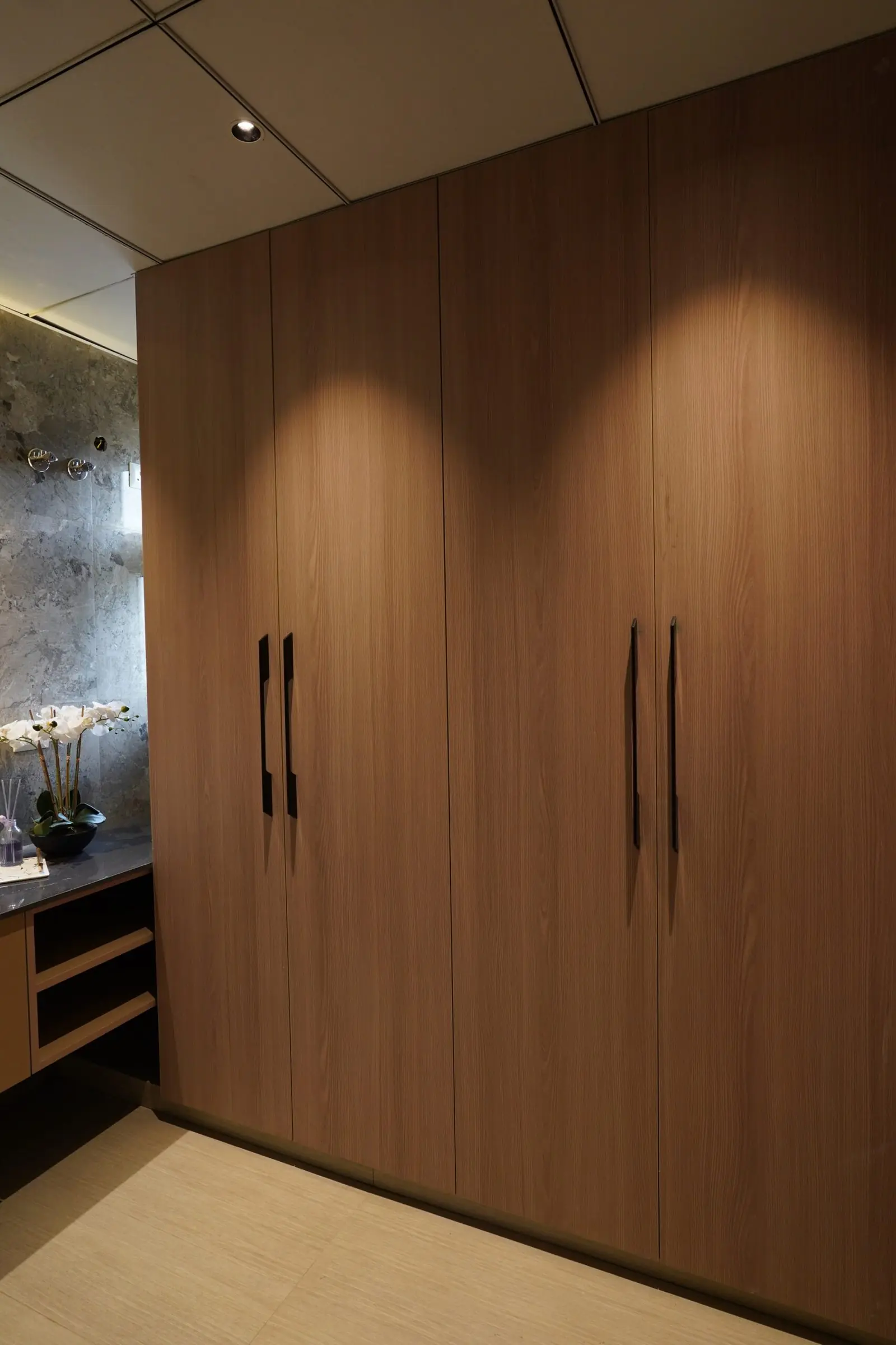 Floor-to-ceiling fitted wardrobes and a dressing counter in a bedroom of the sample flat at AIGIN Royal Park, Ghaziabad