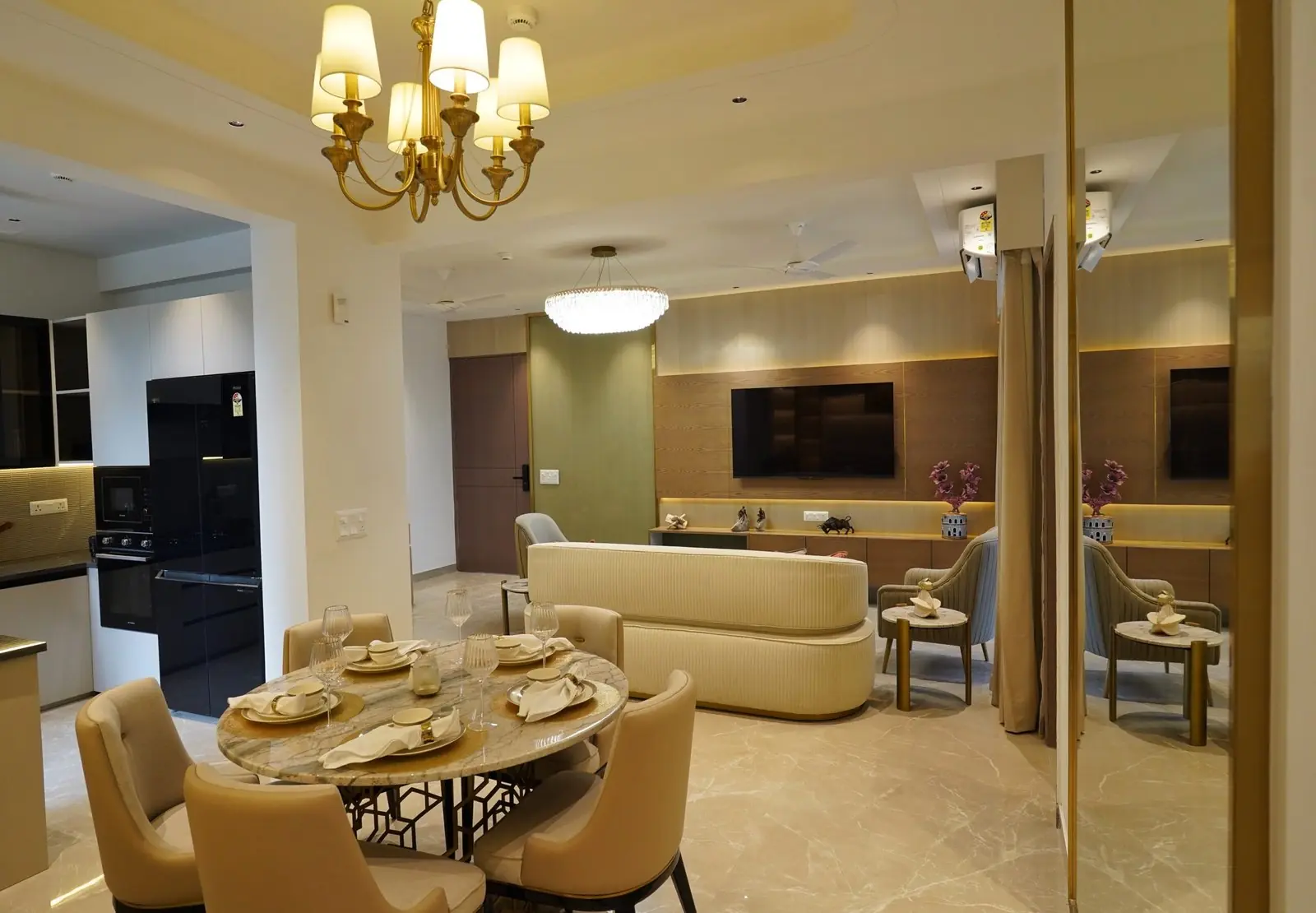Dining area laid for six under a chandelier in the finished 3 BHK sample apartment at AIGIN Royal Park, Ghaziabad